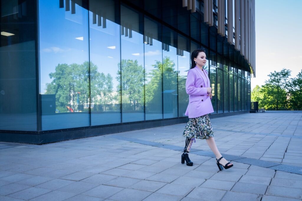 Woman walking confidently outdoors on her prosthetic leg